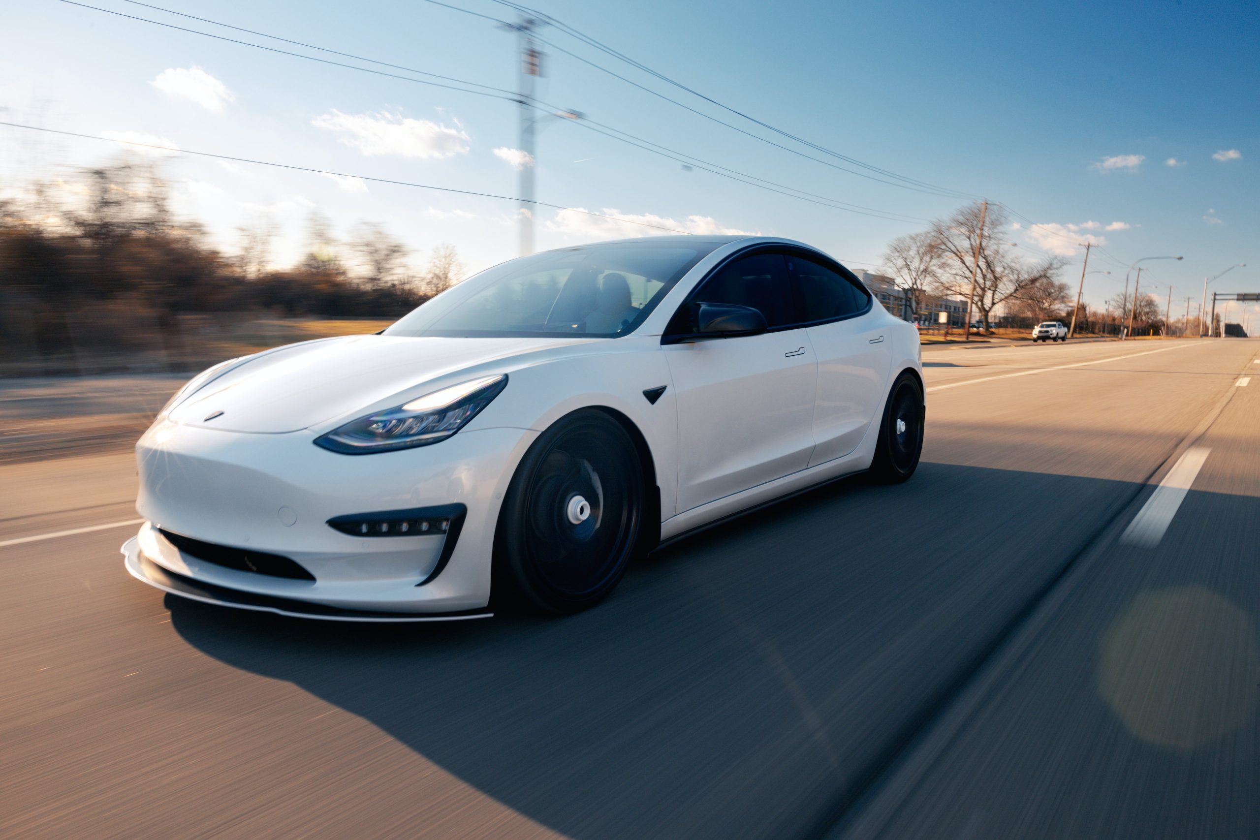 White Tesla driving