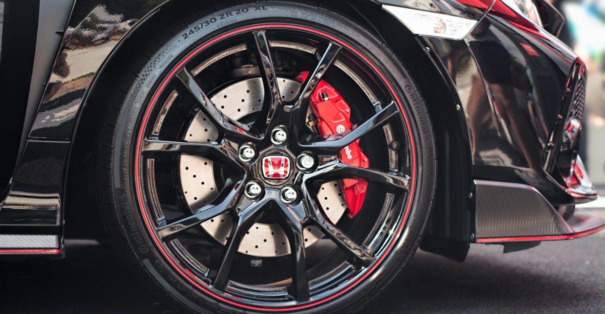 This is a detail shot of the wheel assembly of a Honda Civic Type-R at the 2018 Goodwood Festival of Speed I really like the contrast between the black finish of the car body and the red trim and brake caliper