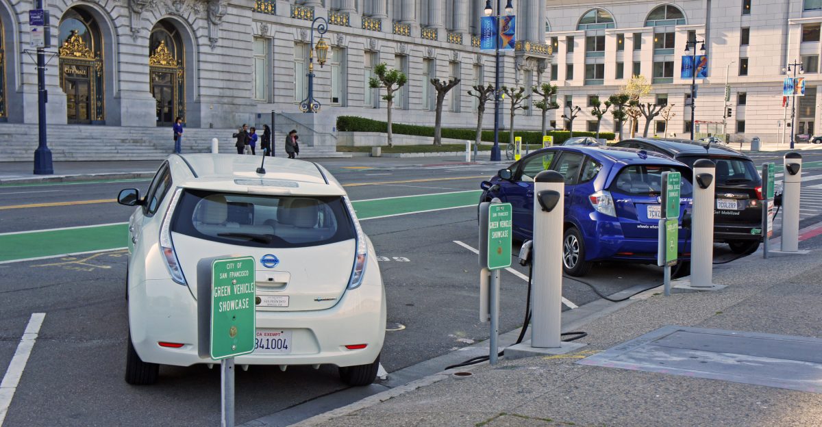 From left to right Nissan Leaf electric car Honda Fit EV electric car and Ford C-Max Energi plug-in hybrid at a public charging station in front of San Francisco City Hall