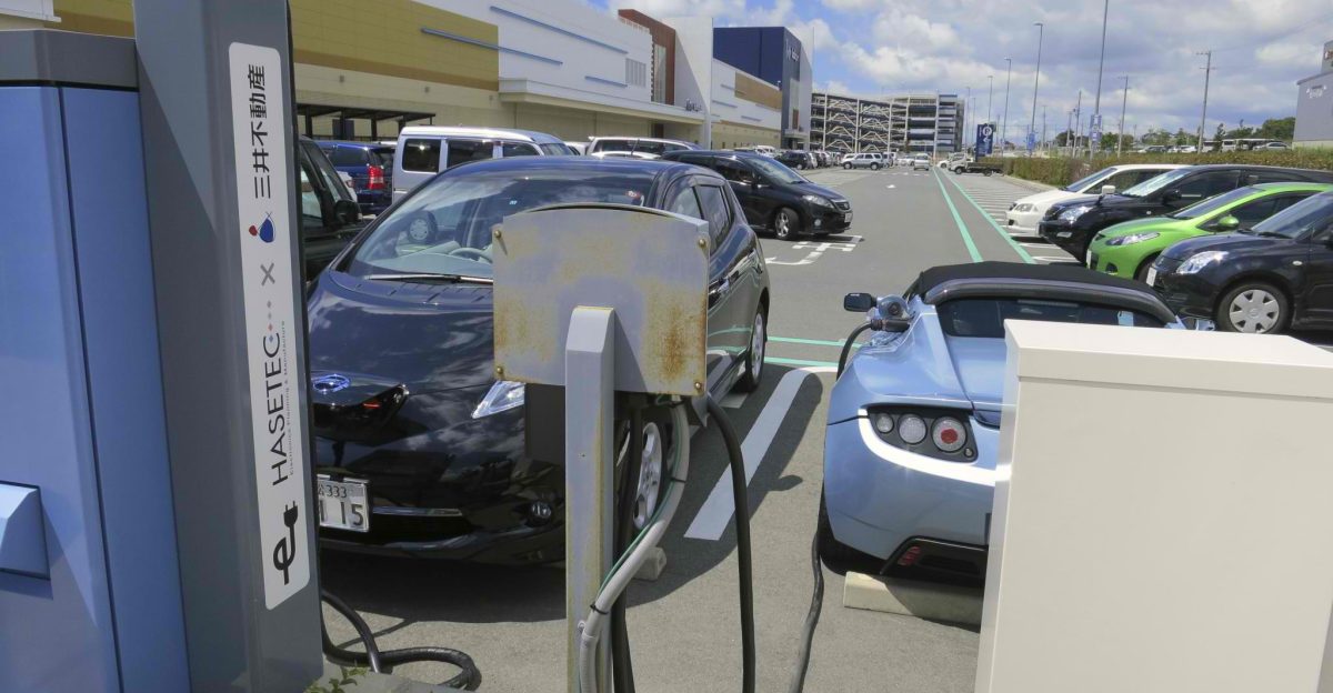 A Tesla Roadster and a Nissan Leaf at an electric vehicle recharging station in Iwata Japan