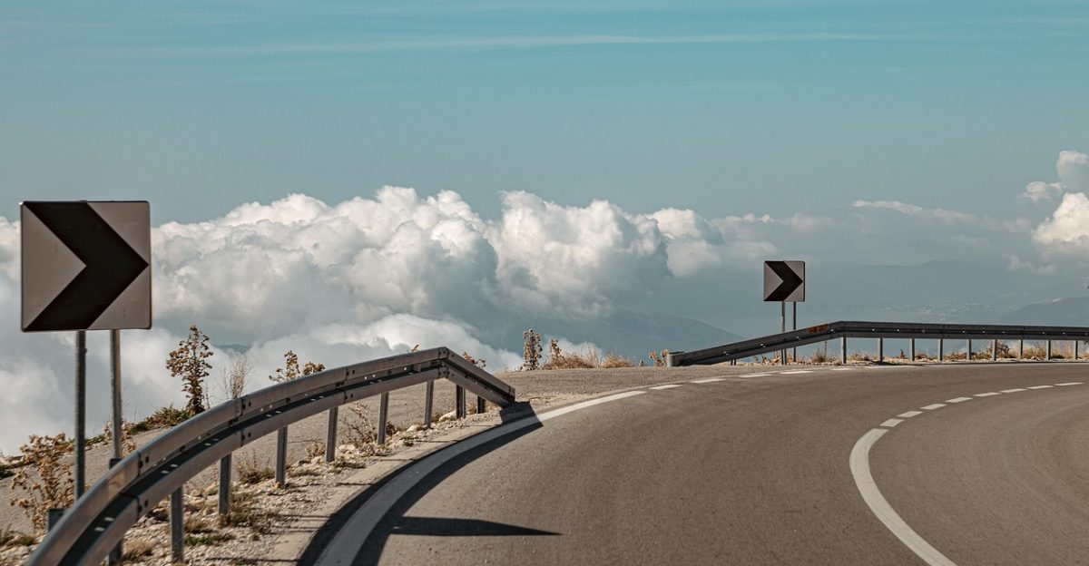 road sign arrow clouds nature sky asphalt outdoors