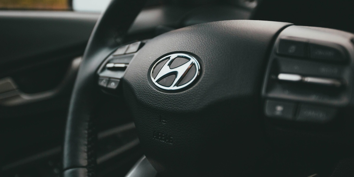 A close-up image focusing on a Hyundai steering wheel inside a car, highlighting design details.