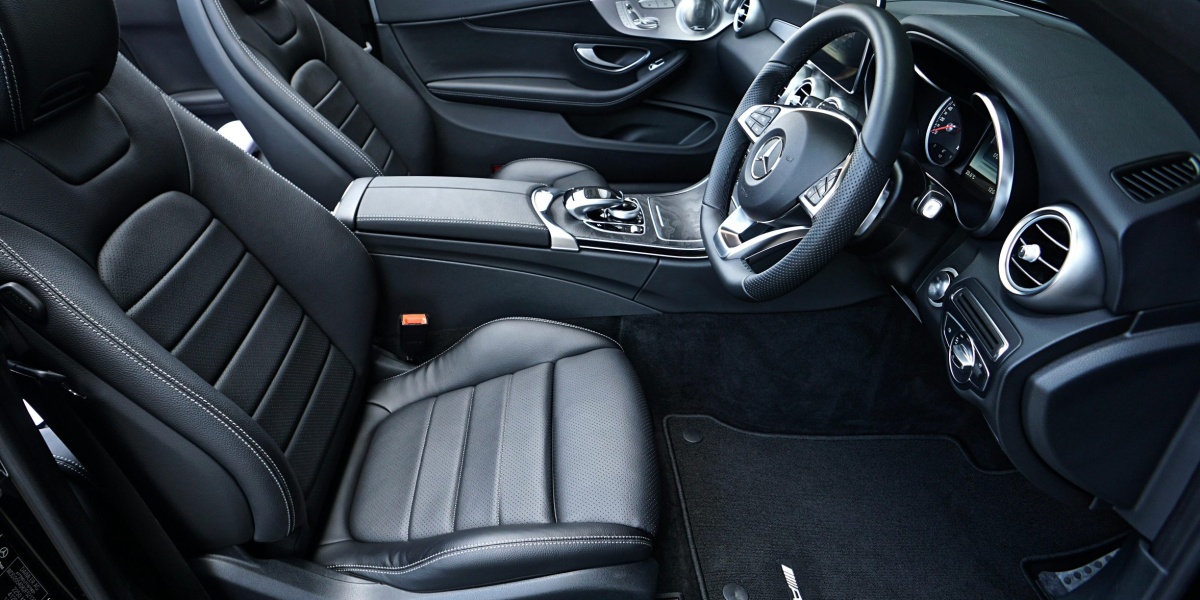 Sleek black Mercedes-Benz interior featuring leather seats and modern dashboard design.