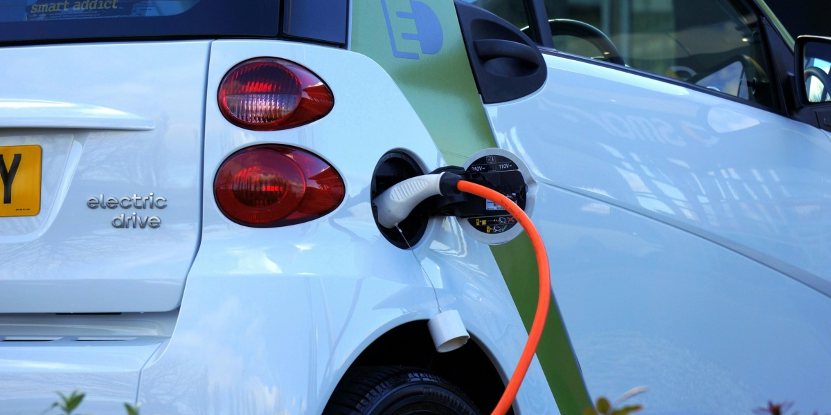 Close-up of an electric car being charged, highlighting eco-friendly transportation.