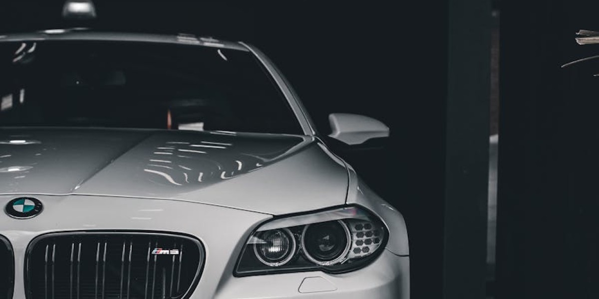 Elegant white luxury car parked indoors showcasing modern automotive design in a dark setting