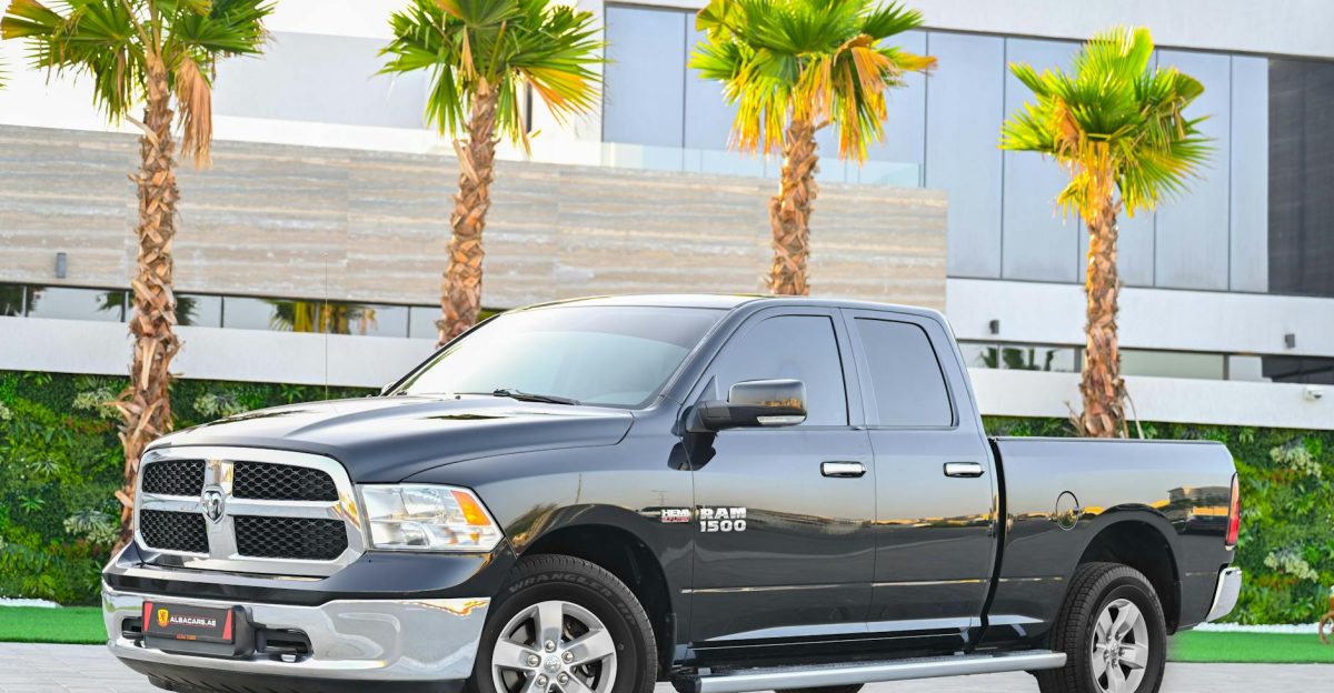 Black Dodge Ram 1500 parked against palm trees in Dubai showcasing luxury and style