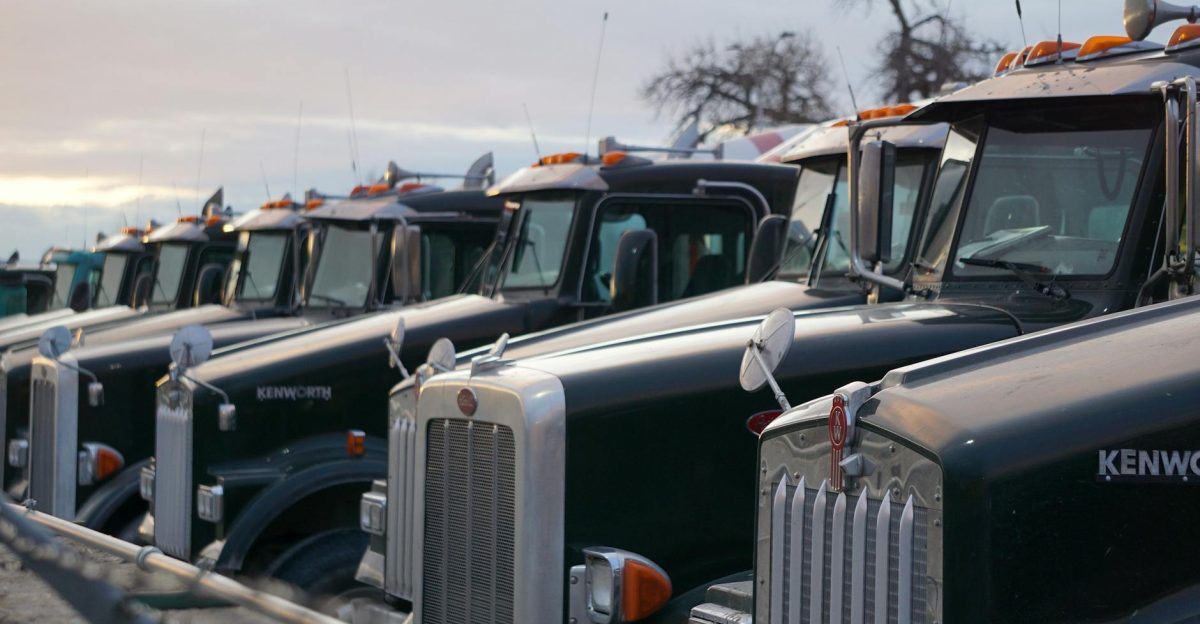 Classic Kenworth trucks lined up outdoors showcasing heavy-duty retro design