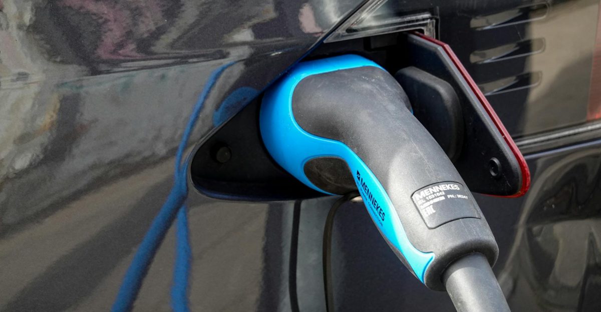 Close-up of an electric vehicle being charged using a Mennekes EV connector