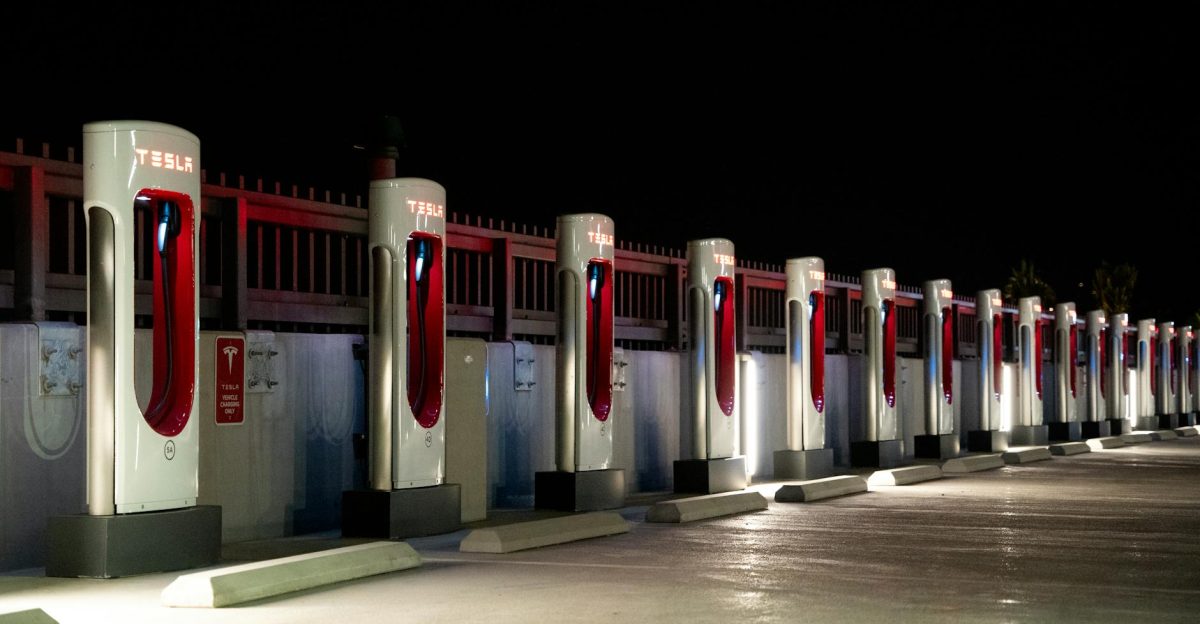 A row of Tesla charging stations illuminated at night in Redlands CA