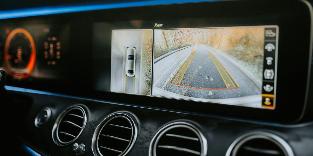 Close-up of a car dashboard showcasing a rear-view camera display and modern electronics.