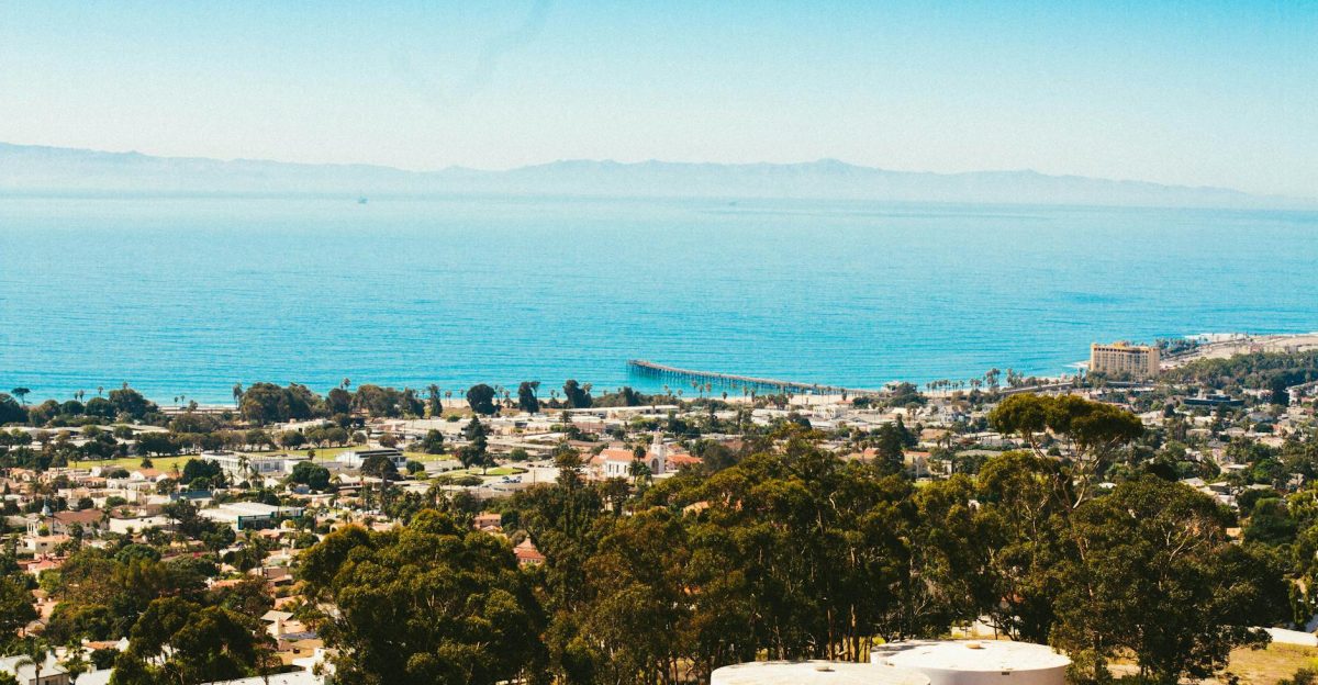 A stunning aerial view of Ventura California capturing the coastal town and ocean on a sunny day