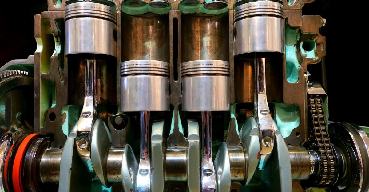 Close-up image of car engine pistons and crankshaft showcasing mechanical components