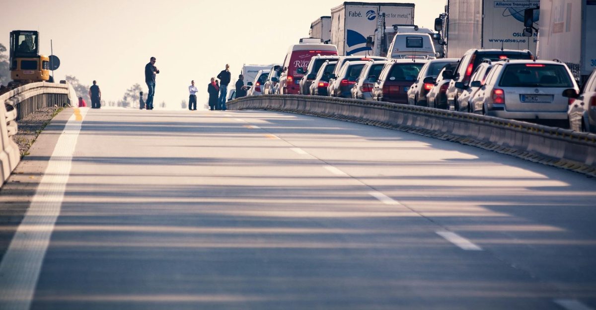 A congested highway with cars and trucks in a traffic jam during daylight