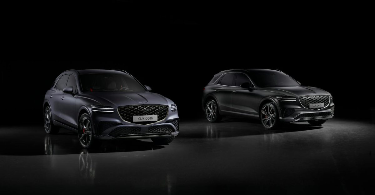 Two Genesis GV70 Sport SUVs showcased in a dramatic studio setting highlighting luxury and design