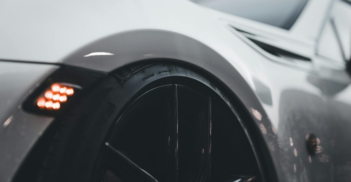 A sleek close-up of a luxury sports car s wheel highlighting its sophisticated design and modern aesthetics