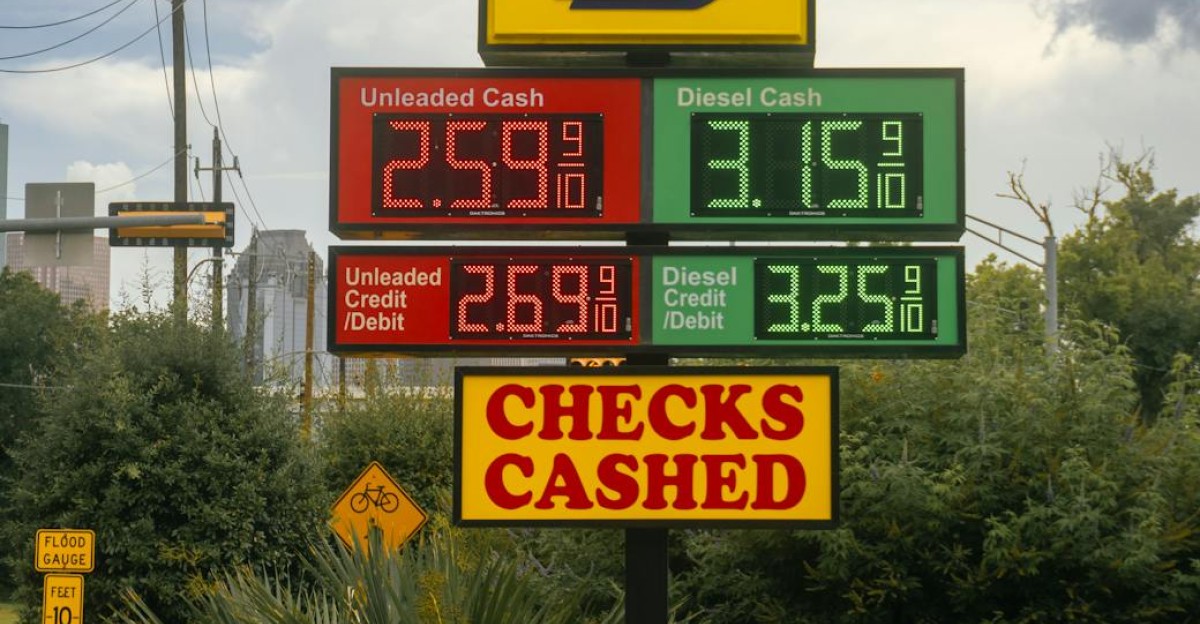 Gas station signboard displaying fuel prices and checks cashed in Houston TX