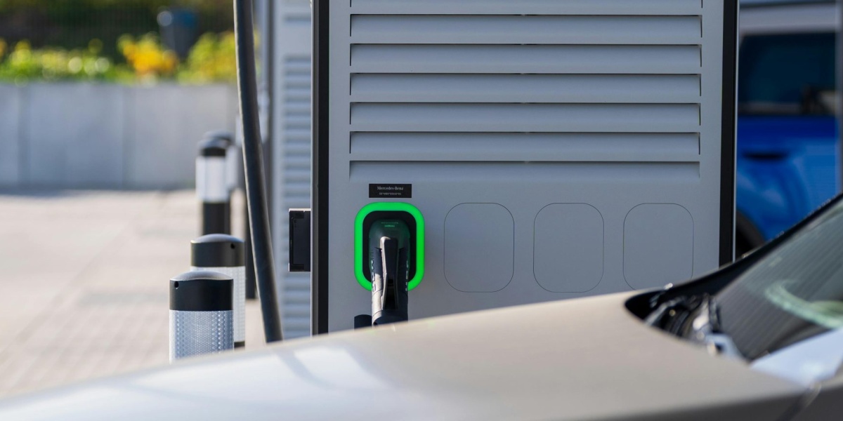 Electric car charging at a modern outdoor station, showcasing eco-friendly technology.