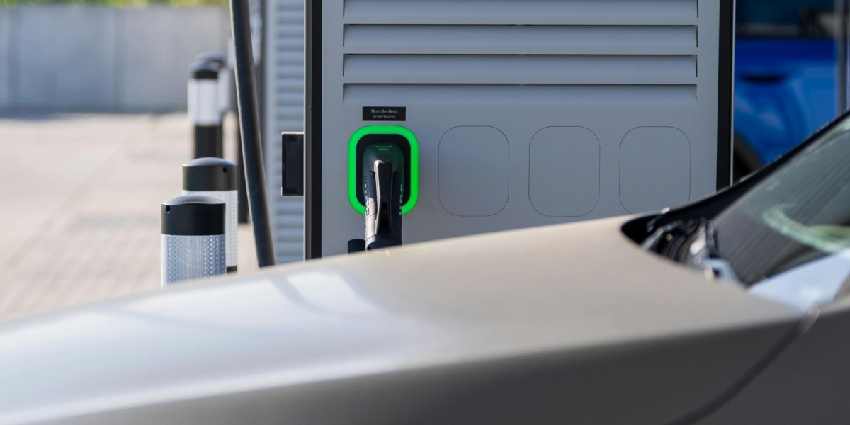 Electric car charging at a modern outdoor station, showcasing eco-friendly technology.