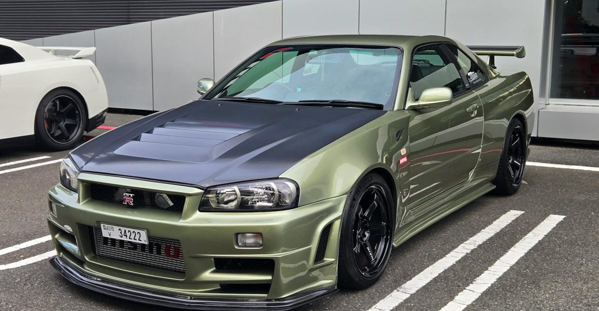 A stylish green Nissan GT-R Skyline R34 parked outdoors in Tokyo Japan