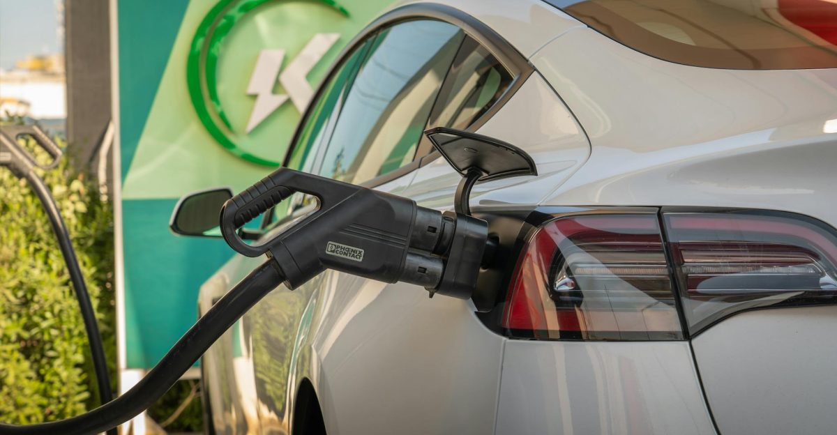 Close-up of Tesla Model 3 connected to a charging station highlighting eco-friendly transportation