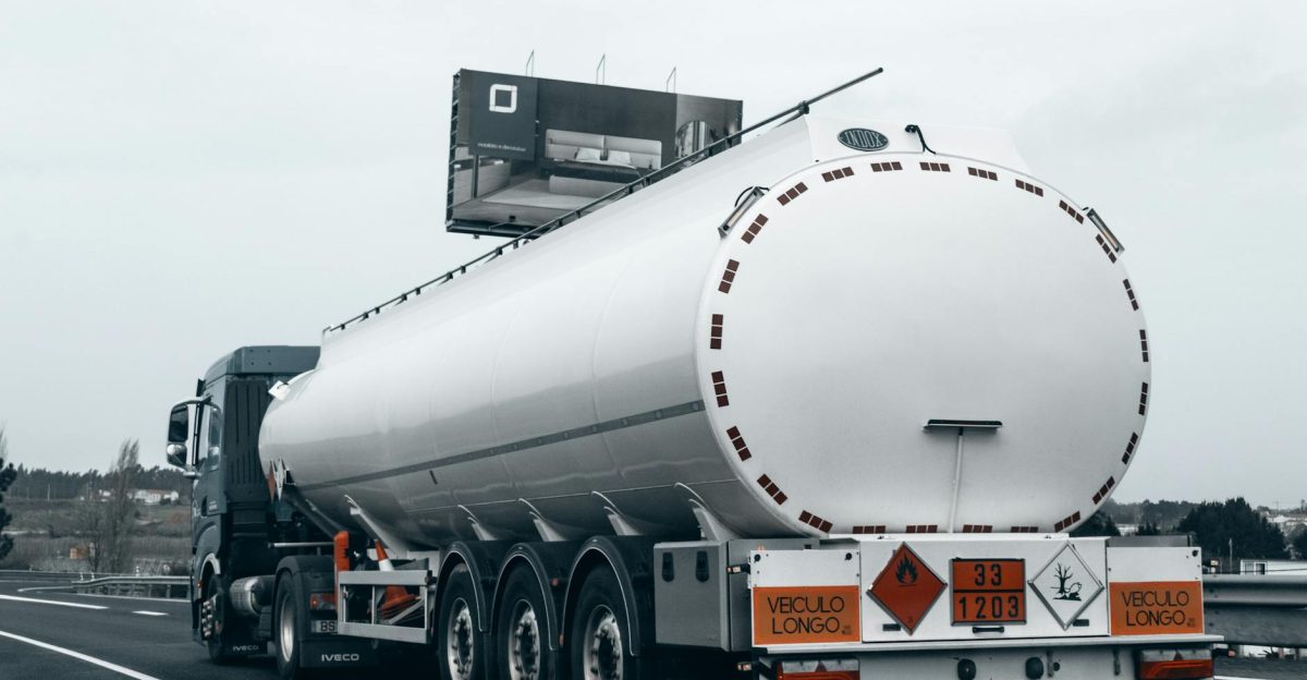 Rear view of a large tanker truck transporting fuel on a highway emphasizing logistics and transportation