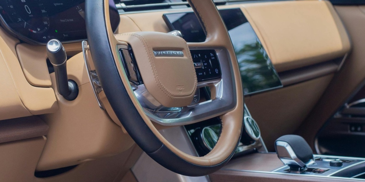 Explore the elegant and sleek tan interior of a modern, luxurious SUV. Perfect for premium travel enthusiasts.