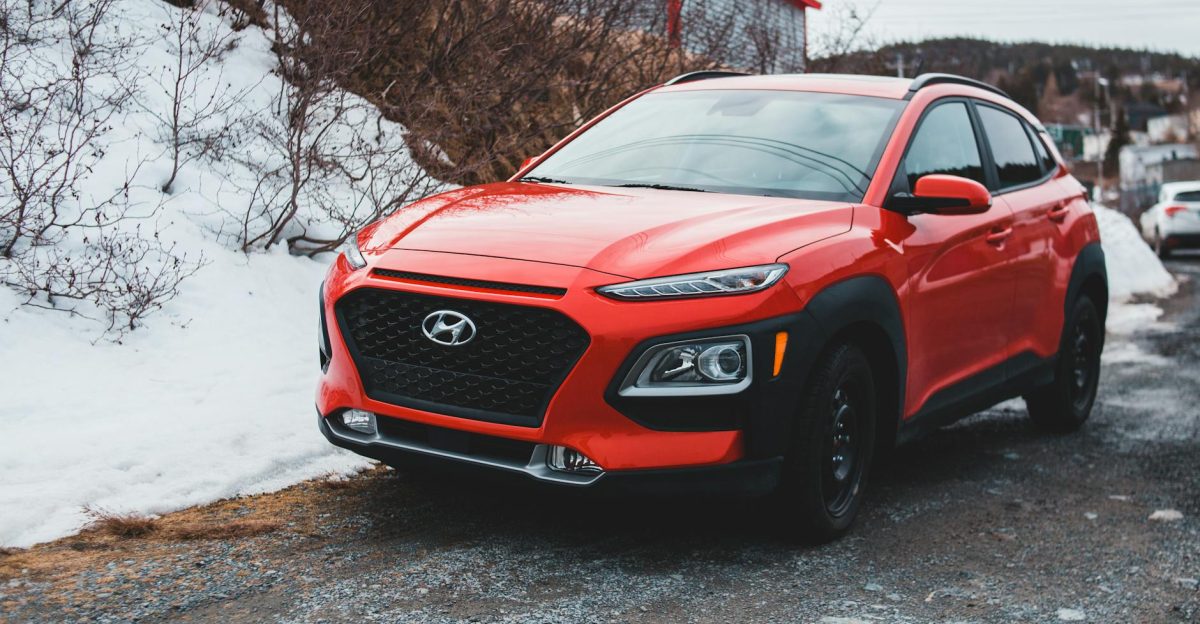 A red Hyundai SUV parked outdoors on a snowy day showcasing modern design and style
