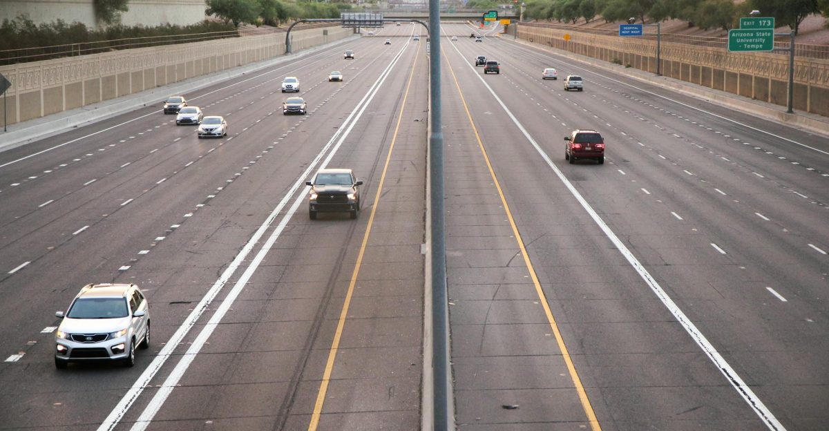 Aerial view of a deserted highway with few cars during dusk depicting calm traffic conditions