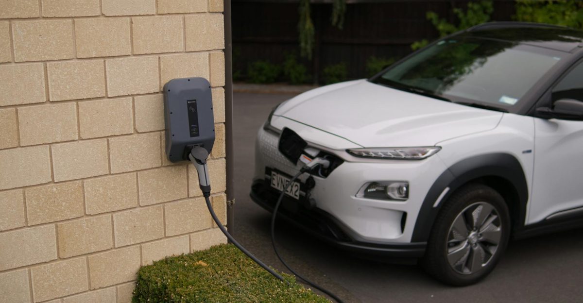 A white electric car charging at a station in Christchurch New Zealand showcasing modern eco-friendly transportation
