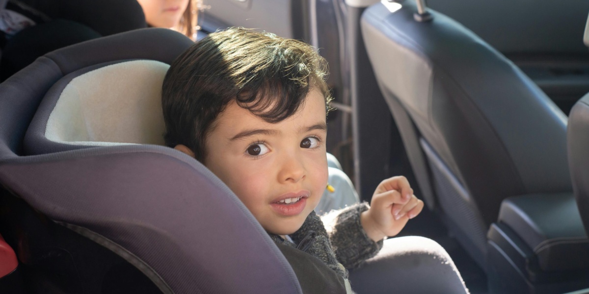 Two children sitting in a car, enjoying a family ride in Portugal.