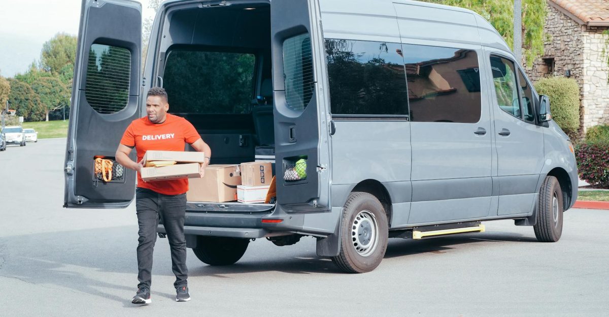 Courier in a delivery van distributing packages in a suburban setting