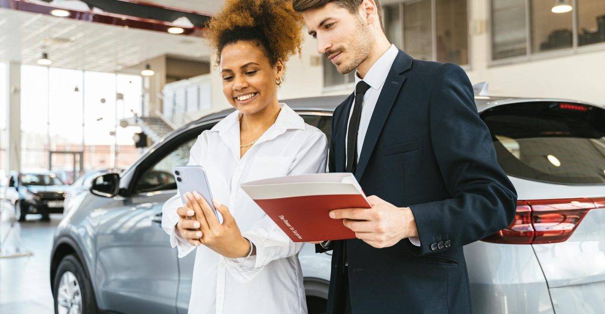 A woman and man smiling while reviewing details at a car dealership Perfect for business or lifestyle imagery