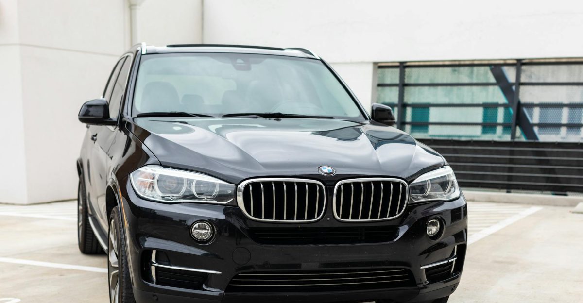 Modern black BMW X5 SUV parked in an urban city environment showcasing luxury design