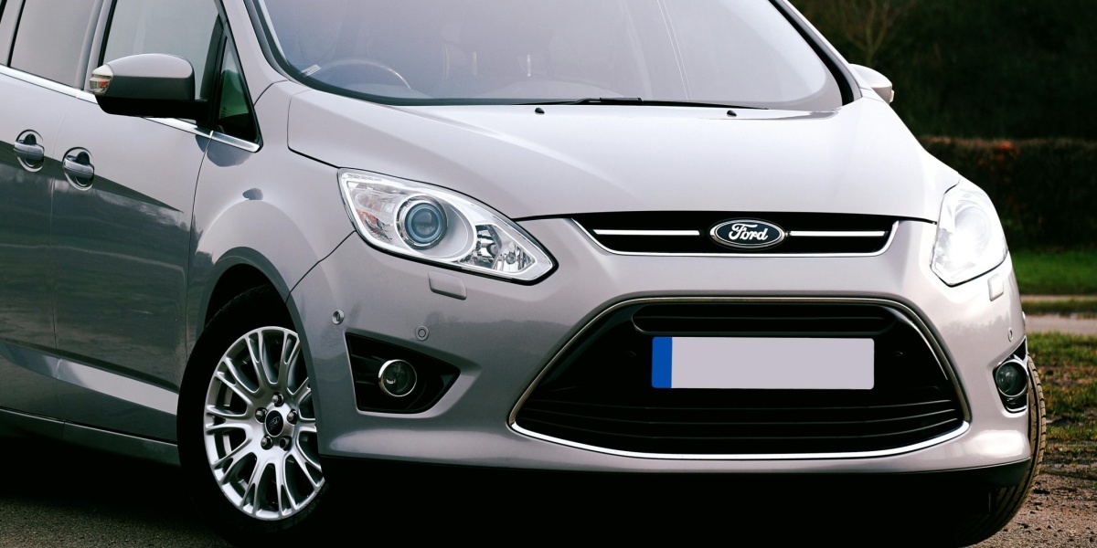 Silver Ford C-Max SUV parked on a road in the UK. Ideal for automotive themes.