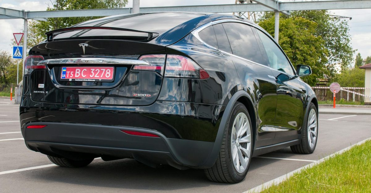 Rear view of a Tesla Model X P100D parked outdoors on a sunny day