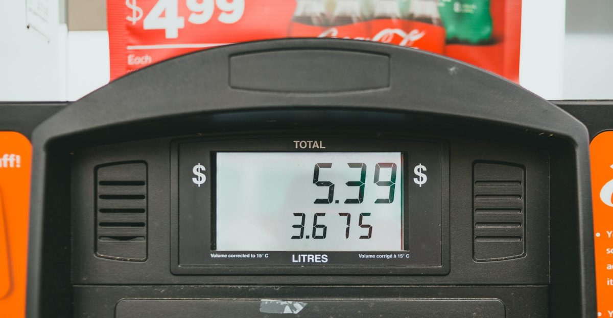 Close-up of a gas pump display showing price per liter and total volume during a transaction