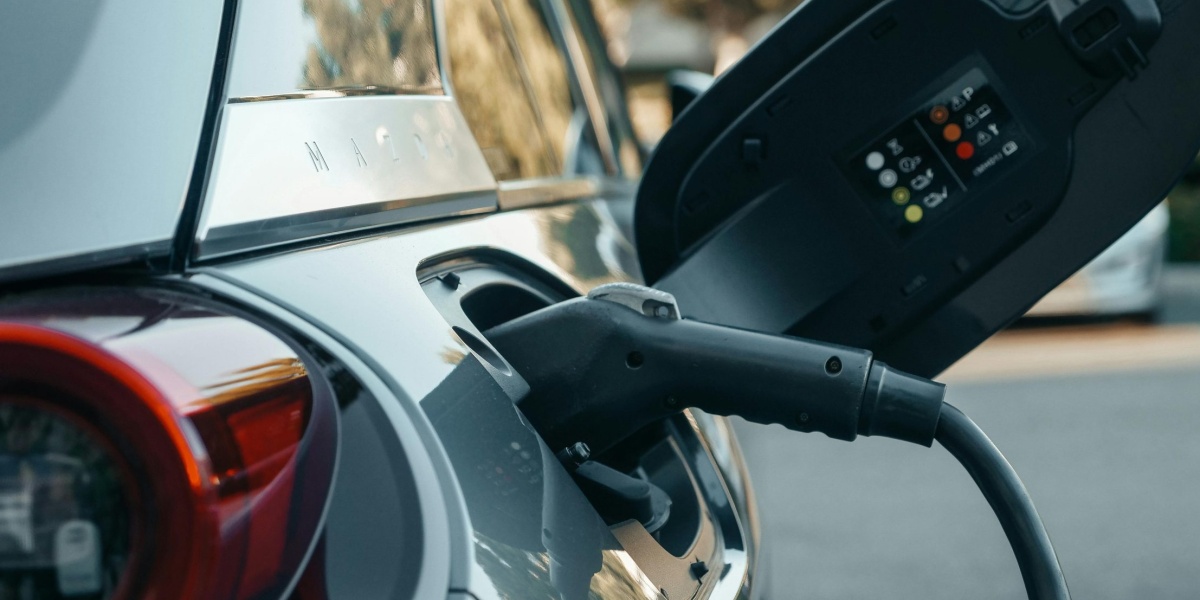 Close-up of an electric vehicle being charged, highlighting modern clean energy technology.