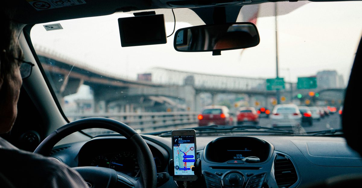 man driving vehicle with GPS system turned on