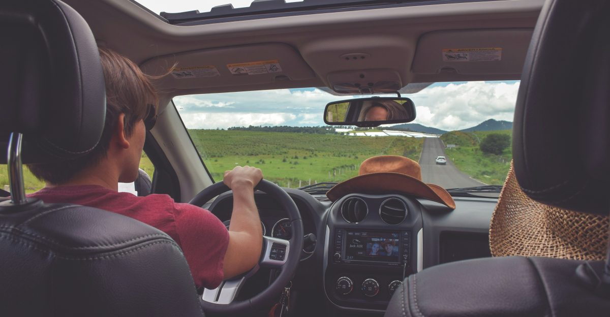 man driving straight on pathway during day time
