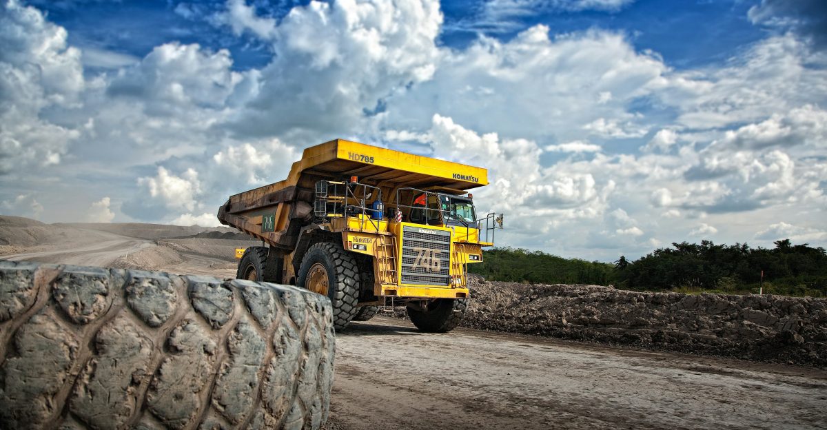 yellow truck on gray road during daytime