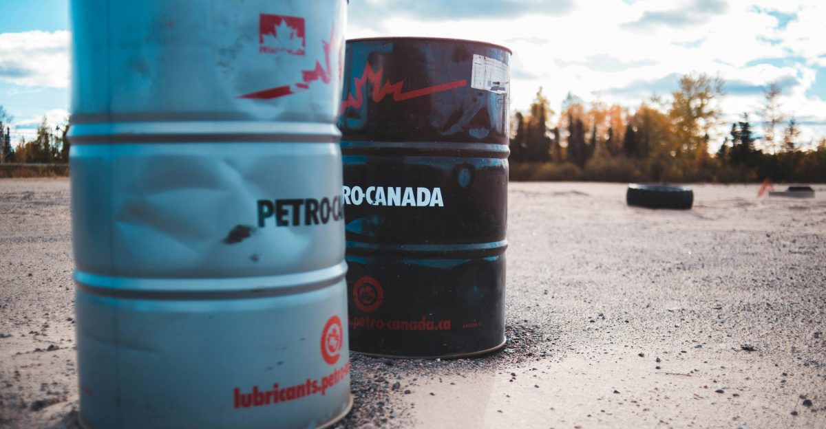 two gray and black metal barrels under cloudy sky