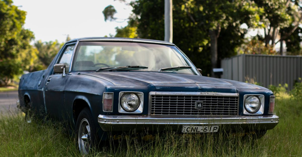 gray coupe parked near tree