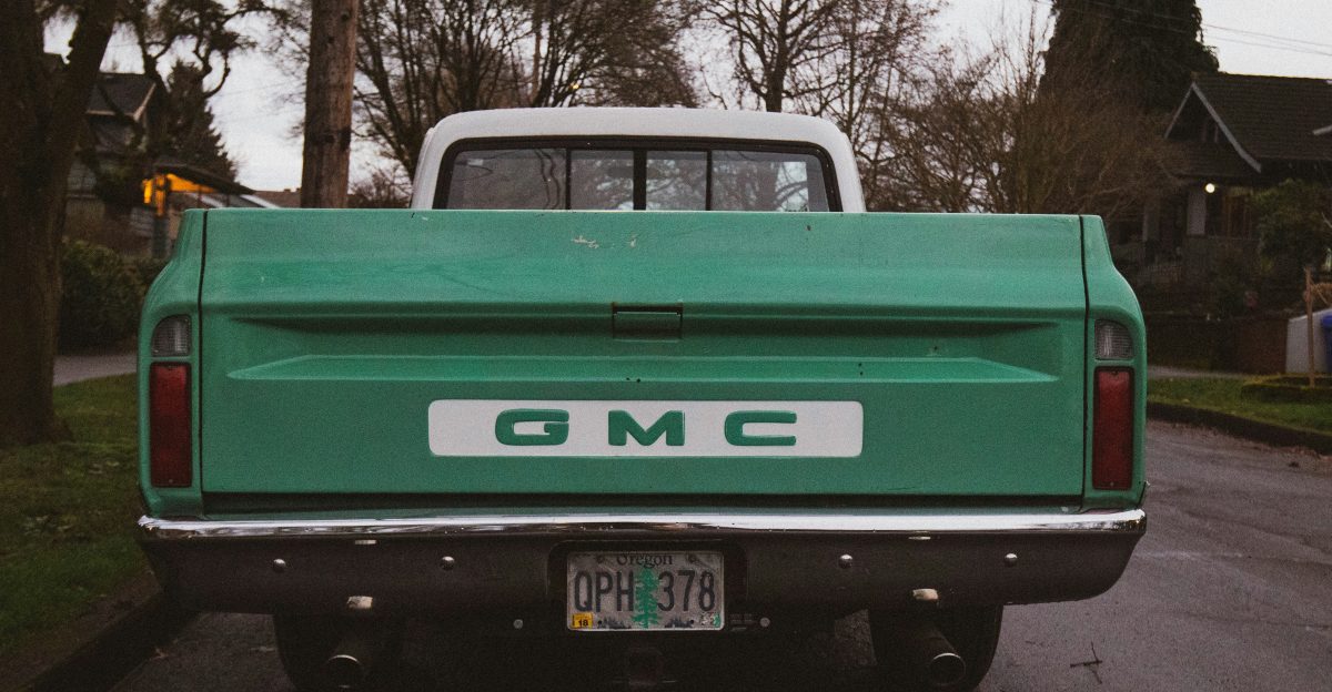 green chevrolet pickup truck parked on road side during daytime