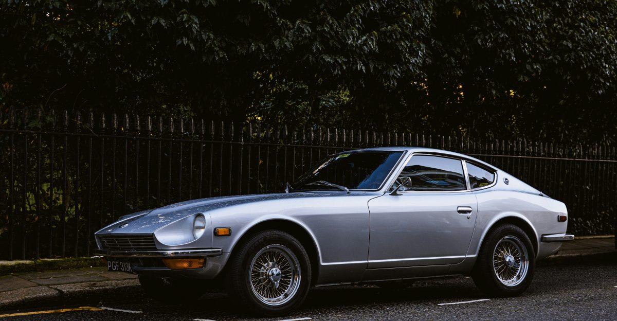 silver coupe parked near trees during daytime