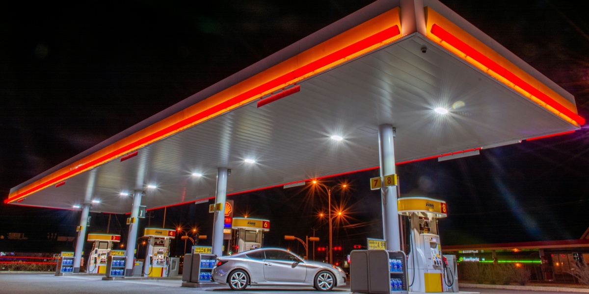 white car parked in front of red and white building during night time