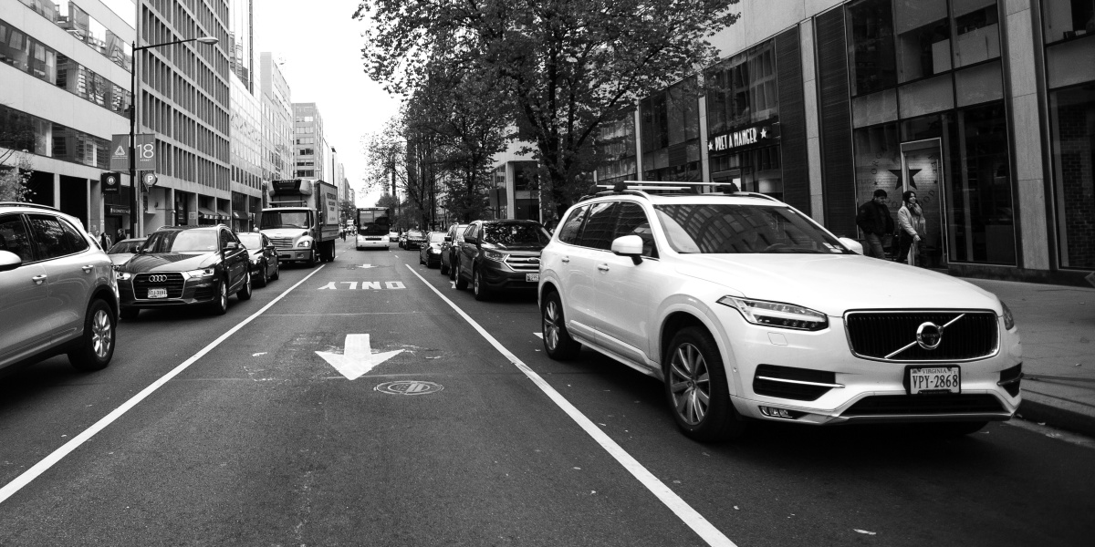 grayscale photo of cars on road