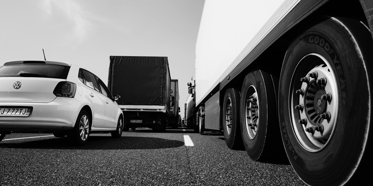 white coupe parked beside white truck
