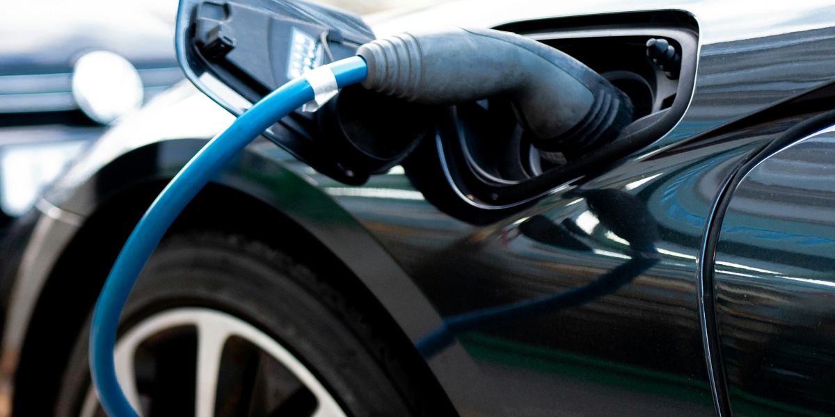 an electric car plugged in to a charger