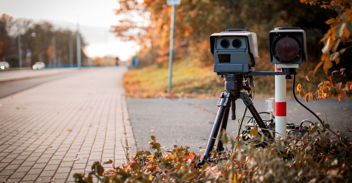 black and gray camera on tripod on road during daytime