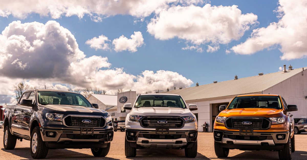 green and yellow chevrolet car on brown sand under blue and white sunny cloudy sky during